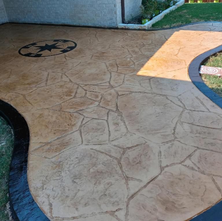 Compass stamp with an accented border on stamped concrete.