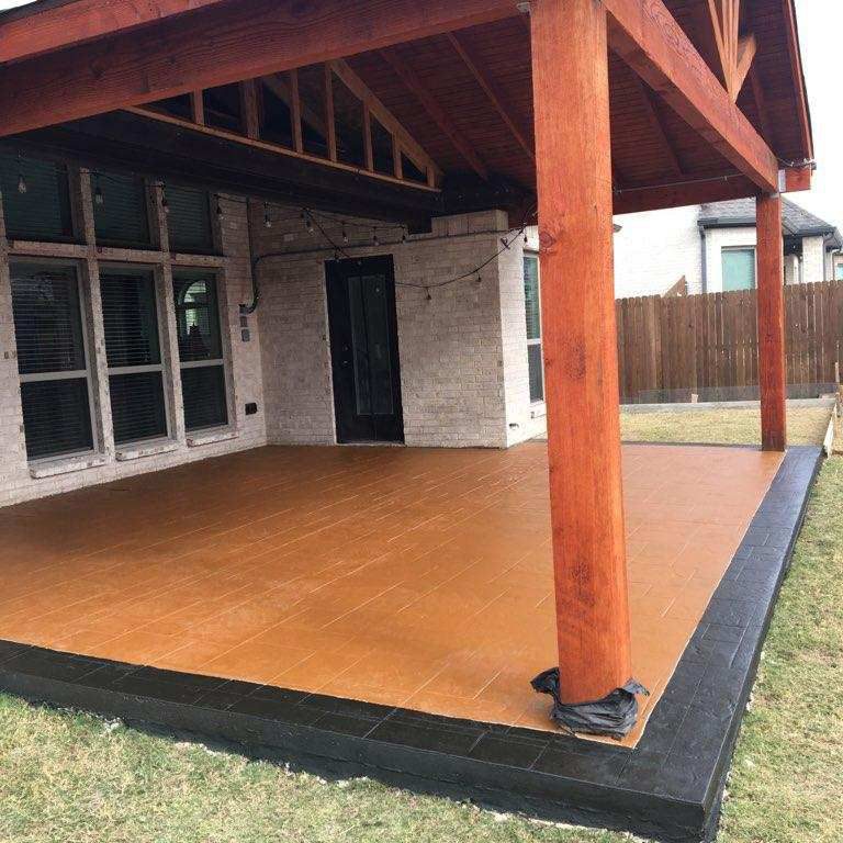 New covered patio with an accented border featuring stamped concrete.